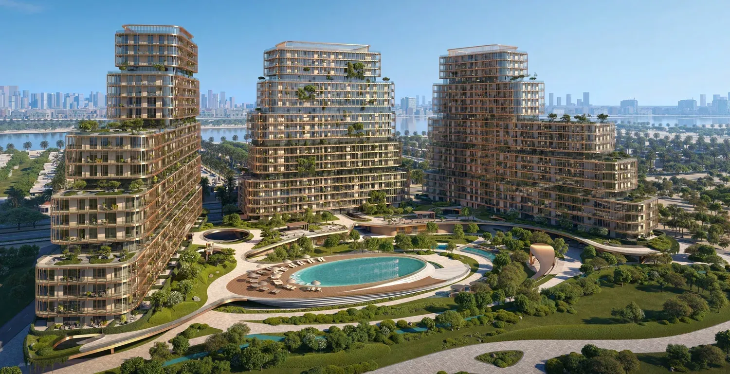 Aerial render of low-rise island residences and a resort pool on Dubai Islands with the Dubai skyline across the water
