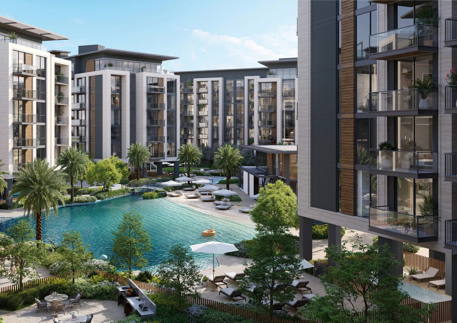 Turquoise lagoon pool set between landscaped mid-rise apartment buildings